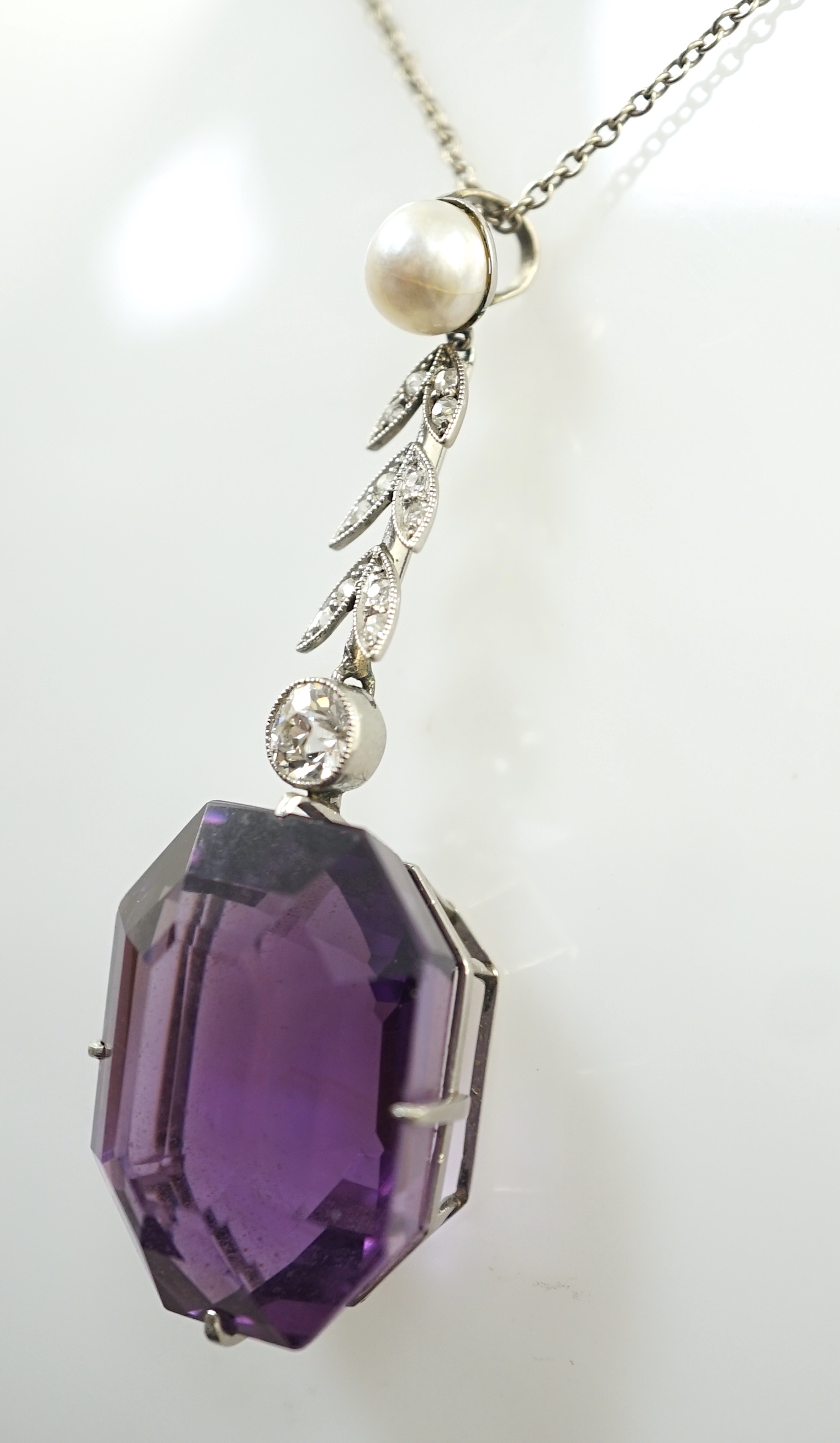 A 1920's white gold, amethyst, diamond and cultured pearl set drop pendant necklace